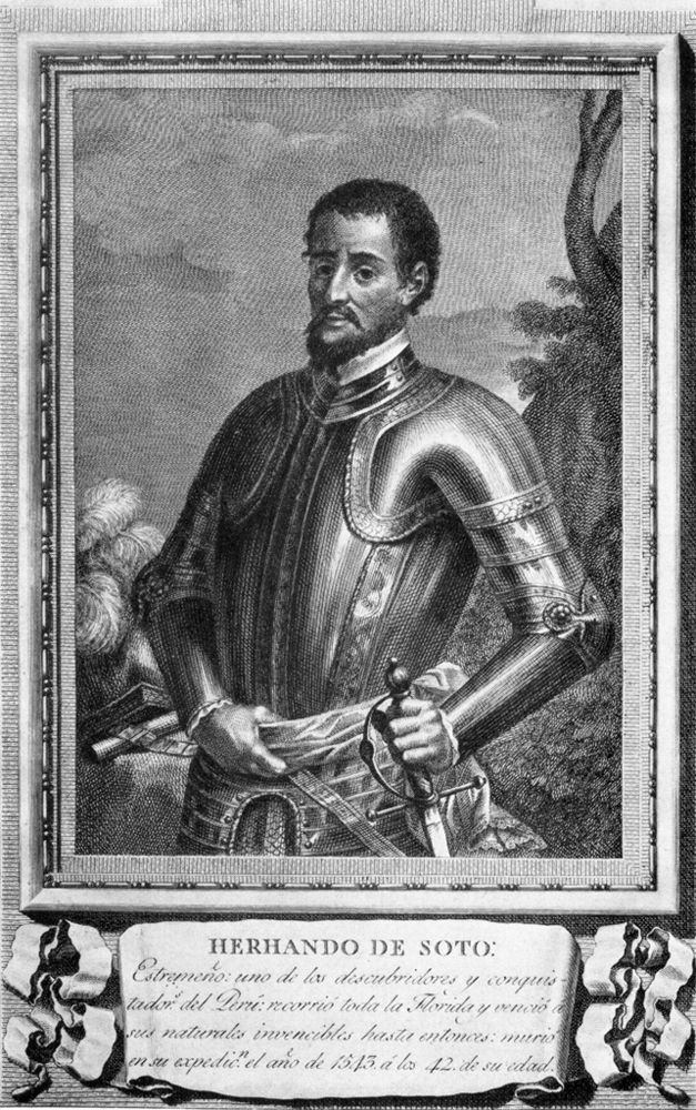 Hernando de Soto. He is depicted wearing armor with wilderness in the background. He has a beard and medium hair. His left hand rests on his sword.