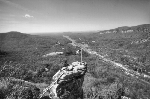 Chimney Rock, with Lake Lure in the distance. Photograph by Charles E. Jones. North Carolina Department of Transportation. Chimney Rock, with Lake Lure in the distance. Photograph by Charles E. Jones. North Carolina Department of Transportation.