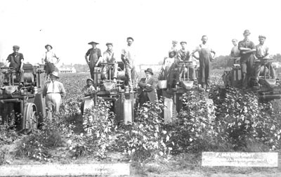 Cotton picking machinery a success; Price Campbell Machines; 2 businessmen and workers pose with 4 machines, near Hamlet, NC, c. 1913; photo by Frank Marchant, Hamlet, NC. From the General Negative Collection, North Carolina State Archives, call #:  N_92_7_31, Raleigh, NC.
