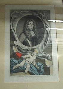 Ashley-Cooper. He has a curly long hair and is wearing a fancy collar and metal armor. There is cherub with a shovel in the foreground. The image is grey and black on a beige page.