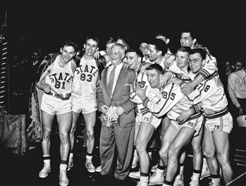 Everett Case, nicknamed the Old Gray Fox, and his North Carolina State basketball team after defeating Wake Forest 82-80 at Reynolds Coliseum in Raleigh to win the first ACC title on 6 Mar. 1954. Raleigh News and Observer.