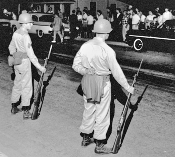 National Guardsmen face off with townspeople in Henderson after being mobilized by Governor Luther Hodges during the Harriet-Henderson Mills strike in May 1959. Courtesy of North Carolina Office of Archives and History, Raleigh. The Raleigh News and Observer files.
