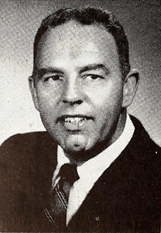 A photograph of radio broadcaster James William "Jim" Reid published in 1957. Image from the Internet Archive.