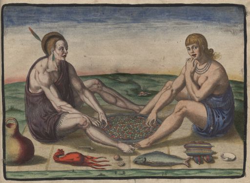 A man and woman sitting on a blanket across from each other.  The man is wearing brown and has a single feather sticking up from his head.  The woman is wearing blue and is earing a beaded necklace.  They appear to be eating.  Food items sit on the blanket around them.