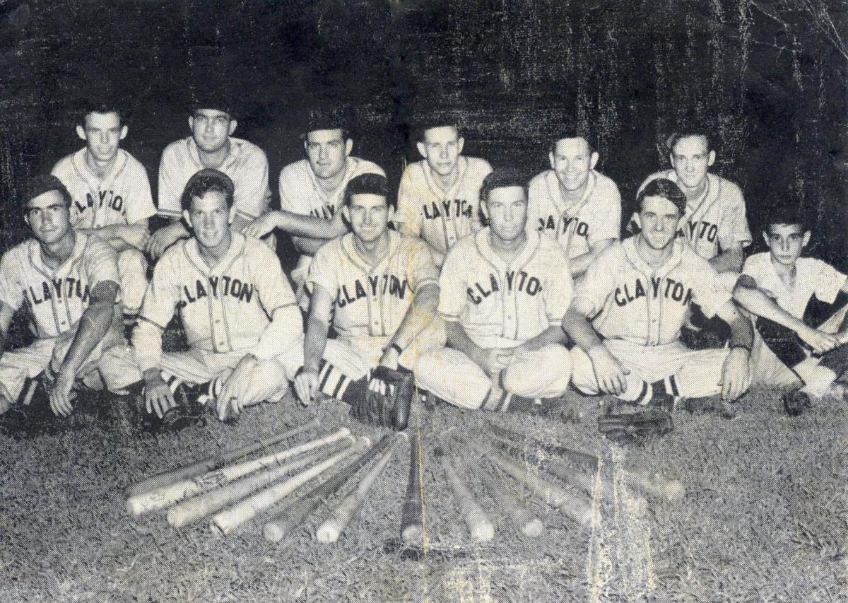 Black and white photo of twelve young men dressed in baseball uniforms that say "CLAYTON" in large capital letters across their chests.