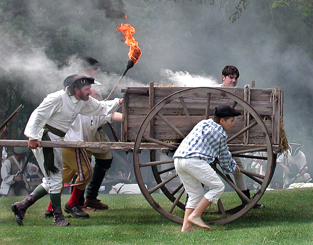 Image of the infamous cart being lit on fire by battle reenactors