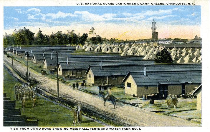A postcard depicting Camp Greene. A general on horseback patrols past tents. 