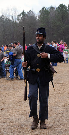 Photograph depicting an African American soldier in the Union Army, taken at a North Carolina Civil War battle re-enactment. Image used courtesy of the North Carolina Department of Natural and Cultural Resources.
