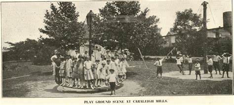 A large group of children crowded around playground equipment located at Caraleigh Mill in Raleigh.
