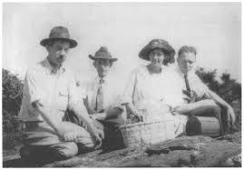 Alma on a botanical collecting trip, circa summer 1921, kneeling on ground with James Coker, Jr, William Coker, and John Couch