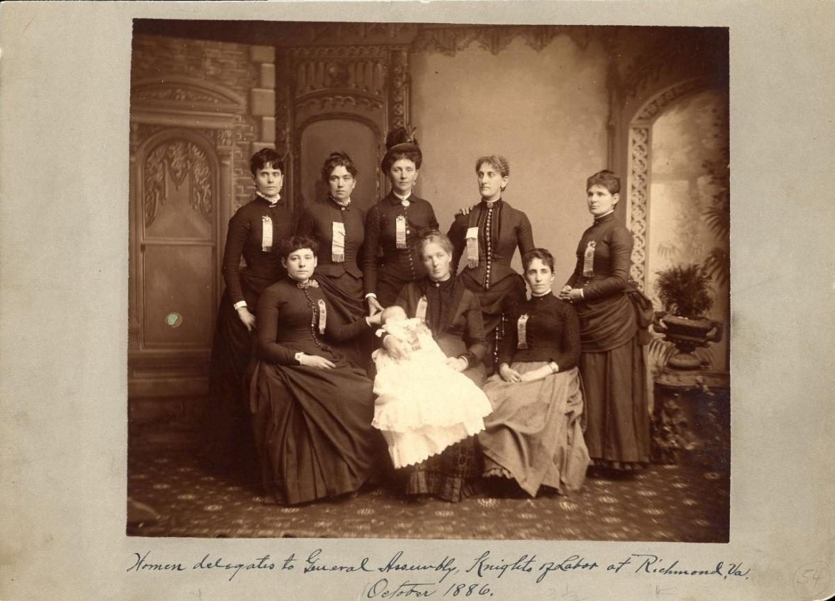 Photograph of eight women, one of whom is holding a baby, with the caption "Women delegates to the General Assembly, Knights of Labor at Richmond, Va., October 1886