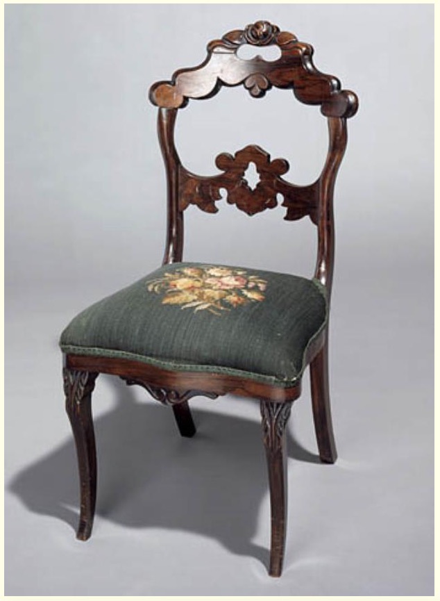 Photograph of a chair created by Thomas Day, around 1850 to 1860. The chair is part of the collection of the North Carolina Museum of History in Raleigh, North Carolina.
