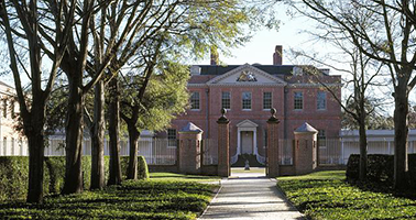 Tryon Palace sits at the end of a large path. It is two stories in the colonial style and is made of brick.
