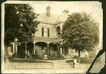 Photograph of Thomas Wolfe and his family in front of the family home in Asheville, N.C., ca. 1913. From the Digital North Carolina Collection Photographic Archives, UNC-Chapel Hill.