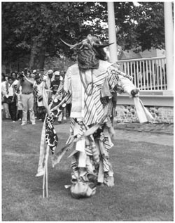 A performer reenacts the Jonkonnu ceremony at Somerset Plantation. The Jokonnu ceremony has roots in Jamaica and possibly Africa. A Christmas morning event, enslaved people would don costumes made of rags or animal skins. There would be dancing and often music or singing, and it was expected that participants would be rewarded with money or gifts by masters or other white people. Image courtesy of North Carolina Office of Archives & History, in association with the University of North Carolina Press.