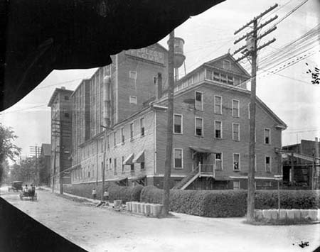 Photograph of the Peerless Flour Factory, ca. 1910, Durham, N.C. industrial district. The factory was located at the corner of Vivian and McMannen Streets. From the Parnell Collection, Durham Historic Photographic Archives, Durham County Library. Courtesy of the NC Digital Heritage Center.