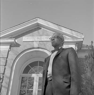 W.H. Davenport standing in front of Greenville, N.C.'s C. M. Eppes High School, January 19, 1961. Item 741.26.a44, from the Daily Reflector Image Collection, East Carolina University Digital Collections.