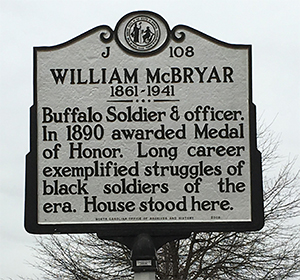 Photograph of the NC Highway Historical Marker for William McBryar, located at East Market and Dudley Streets in Greensboro, NC. Image used courtesy of the Research Branch, NC Office of Archives and History.
