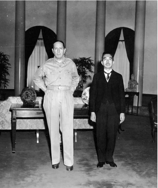 MacArthur and Hirohito standing side by side in an office. 