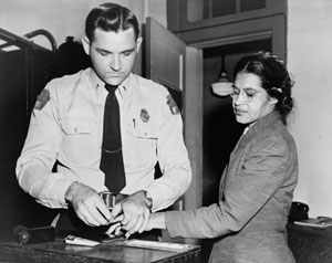 This is a photograph of Rosa Parks being fingerprinted by a white police officer after her arrest for refusing to give up her bus seat, December 1, 1955.