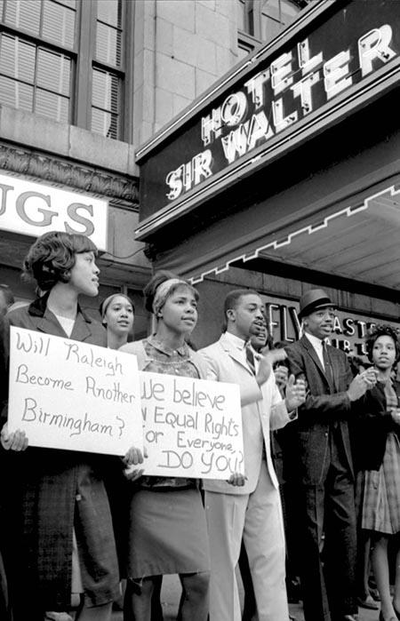 African Americans picketing in Raleigh, North Carolina, outside of the Sir Walter Hotel (1963) This is an image of African Americans picketing in Raleigh, North Carolina, outside of the Sir Walter Hotel in 1963.