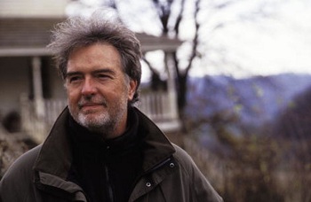 Author photo of Charles Frazier looking into the distance, standing in front of a house.