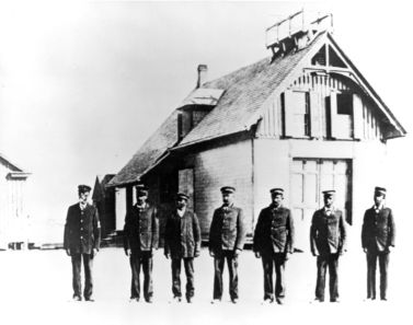 "Richard Etheridge, far left, and the Pea Island Life-Saving crew in front of their station, circa 1890. U.S. Coast Guard photo." Image courtesy of the official U.S. Coast Guard Blog, 2010. 