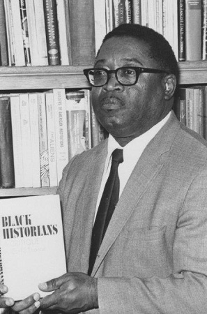 Photograph of Dr. Earlie Endris Thorpe holding a copy of his 1971 book, Black Historians- A Critique
