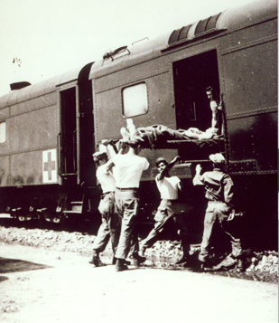"A patient is loaded into an Army hospital car." Photo owned by NC Transportation Museum. http://www.nctrans.org/