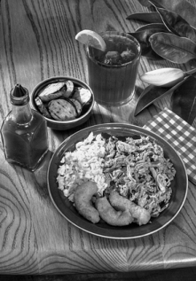 A traditional North Carolina barbecue meal, with pulled pork, coleslaw, hush puppies, fried squash, hot sauce, and iced tea. Photograph courtesy of North Carolina Division of Tourism, Film, and Sports Development.