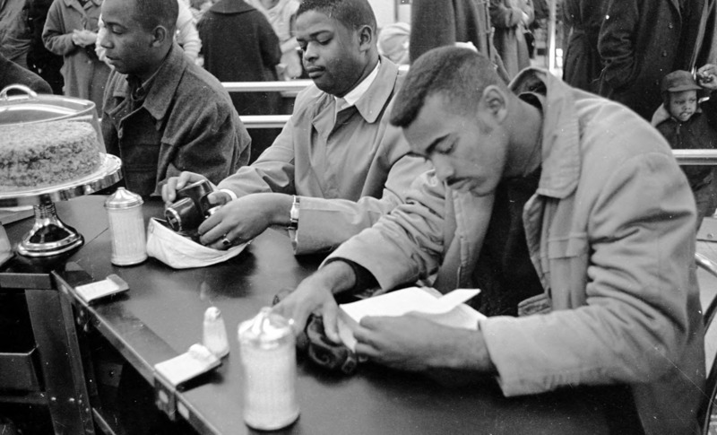 Photo of African American sitting at a counter