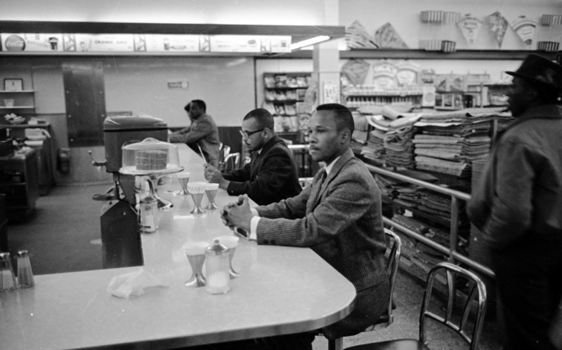 Photo of African American sitting at a counter