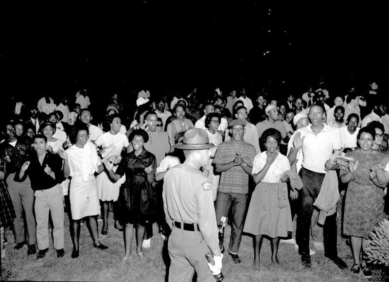 A group of African American protesters chanting and clapping on the lawn of the Executive Mansion in Raleigh