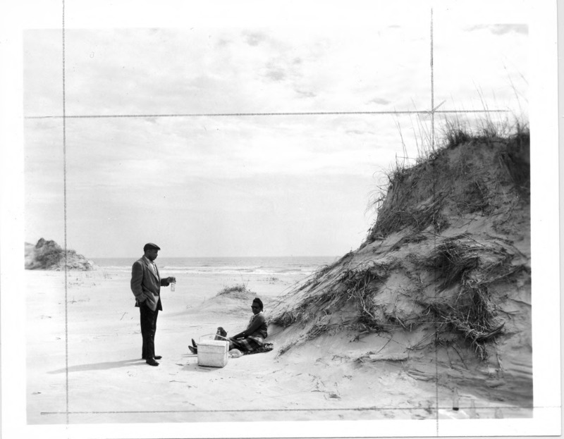 C. Payne Lucas and his wife, Freddie Hill Lucas, picnic on the beach, circa 1960. Payne Lucas, born in Spring Hope, N.C., was active in the Civil Rights Movement in the 1950s, served in the U.S. Air Force, and earned a master's degree in government, all before he joined the Peace Corps in 1962 for ten years of service in Africa. When he returned to the United States in 1971, he co-founded and served as president of Africare, a non-profit organization specializing in aid to Africa. Since his retirement from Africare in 2002, he has continued to be an AIDS activist, and has received several national awards for public service. Dr. William Sharpe of New York purchased Bear Island and a mainland site known as "the Hammocks" in the 1920s. At the suggestion of the estate caretakers, John and Gertrude Hurst, Sharpe donated the land to the North Carolina Teachers Association, an organization for African American teachers, in 1950 to manage as a beach for African Americans during a time when public beaches were segregated. The Hammocks Beach Corporation was then organized to develop the island for recreation, but after unsuccessful attempts to raise funds, negotiated with the state to open Hammoks Beach as a state park for African Americans in May 1961. Several years later, the park was integrated and opened to all.