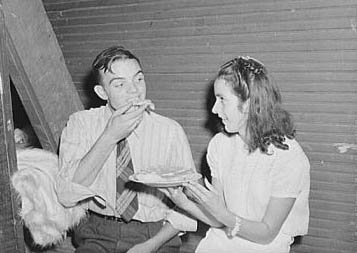 "  Many parents and young people from the school and nearby communities attend the pie and box supper, given by the school to raise money for additional repairs and supplies. Each box or pie is auctioned off to the highest bidder, sometimes bringing a good deal, since the girl's "boyfriend" usually wins and has the privilege of eating it with her afterwards." 1944. Image courtesy Library of Congress.