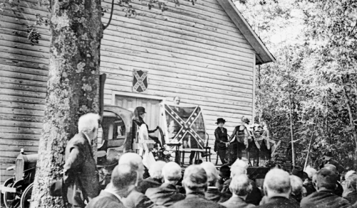 Confederate Memorial Day ceremony at Woodington Universalist Church in Lenoir County, 1920. The event was staged on the bed of a truck parked at the church entrance. North Carolina Collection, University of North Carolina at Chapel Hill Library.