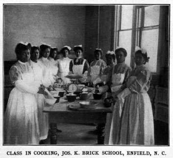 Image of cooking class at the Brick School, ca. 1910. From <i>Era of progress and promise, 1863-1910 : the religious, moral, and educational development of the American Negro since his emancipation</i>. The Clifton Conference. Boston: Priscilla Publishing Co., 1910. From the collection of the N.C. Government & Heritage Library.
