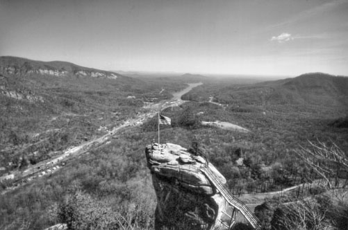 Chimney Rock, with Lake Lure in the distance. Photograph by Charles E. Jones. North Carolina Department of Transportation.