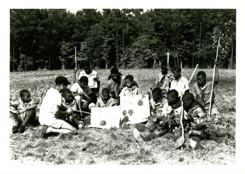 Boyscouts learning about native plants and animals at Crabtree Creek or Reedy Creek State Park, ca. 1940s to 1950s. Crabtree Creek had two park entrances during segregation. In 1950, the southern entrance at Reedy Creek and its surrounding 1,234 acres were split into a separate state park exclusively for African Americans. North Carolina State Parks Collection, NC Digital Collections.