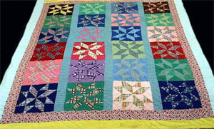 Pieced star pattern quilt, made by Elizabeth Lee Graham Jacobs, 1963, Columbus County, N.C.  From the collections of the North Carolina Museum of History.