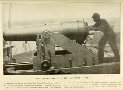 "Whistling Dick," a large cannon. It is being operated by a man roughly half its size.