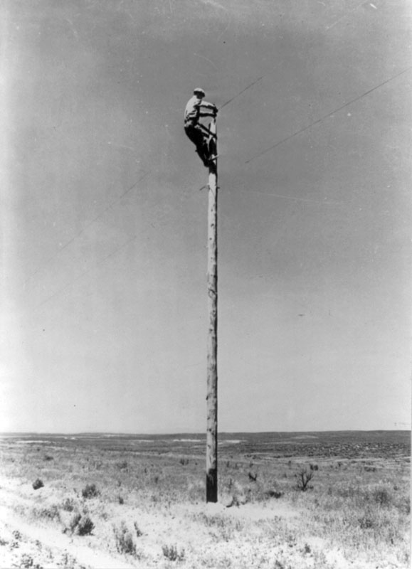 An REA lineman at work on the Great Plains