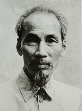 Ho Chi Minh photo. He has thinning hair and a medium, thin beard. He is older in this photo and is wearing a collared shirt.