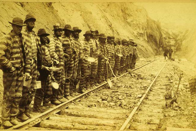 Convict labor working on a railroad
