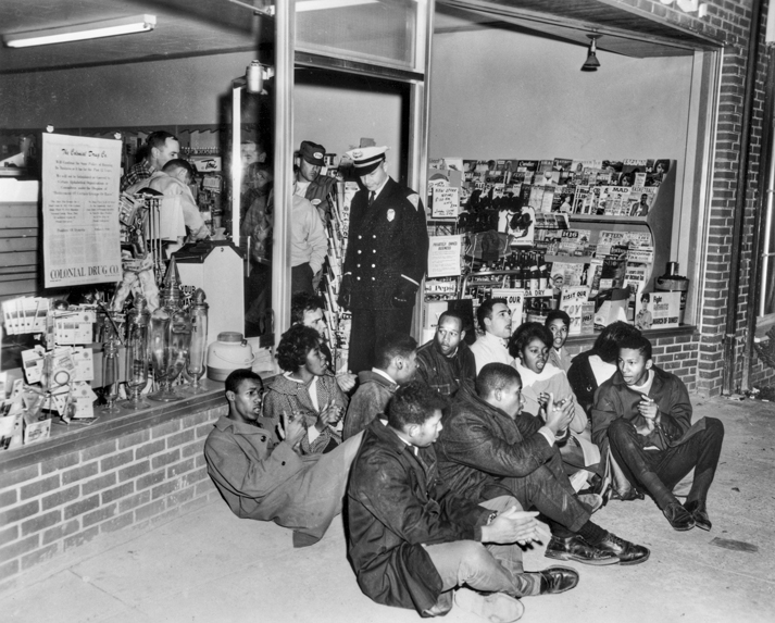 Demonstrators block the entrance to Colonial Drug Store in Chapel Hill in 1964 to protest its policy of serving whites only. North Carolina Collection, University of North Carolina at Chapel Hill Library.