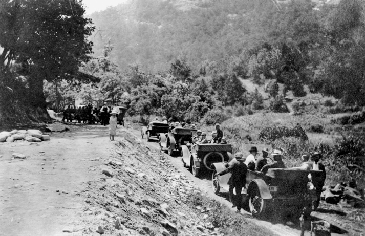 Automobiles, thought to be part of a caravan organized to illustrate the need for better roads, pause at Hickory Nut Gap near Asheville, 1916. North Carolina Collection, University of North Carolina at Chapel Hill Library.