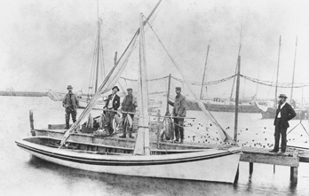 Fishermen at Manteo pose with their catch behind a Roanoke Island shad boat, ca. 1900. North Carolina Collection, University of North Carolina at Chapel Hill Library.