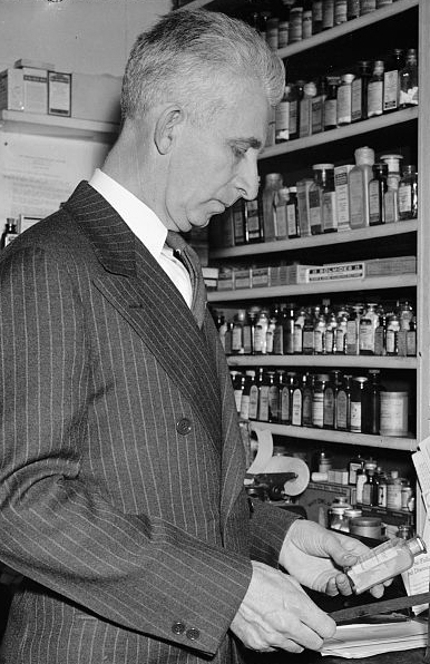 Harris & Ewing. "Only Druggist in Congress. Washington, D.C., Feb. 13. While many professions and businesses are represented in the 76th Congress, Rep. Carl T. Durham, democrat of North Carolina, is the only pharmacist in that august body. He ran a drug store at Chapel Hill before his election to the house, 2-13-39". Photograph. 1939 February 13. LC-H22-D- 5782. Prints and Photographs Division, Library of Congress.