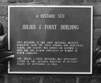 A photograph of the plaque on the Julius I. Foust building on the UNC-G campus. Formerly called the Administration Building it was renamed for Foust in 1960, and put on the National Register of Historic Places in 1980.