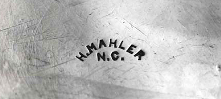 Henry Mahler's hallmark, or maker's mark, stamped on the bottom of a beaker made by him. Image from the North Carolina Museum of History.